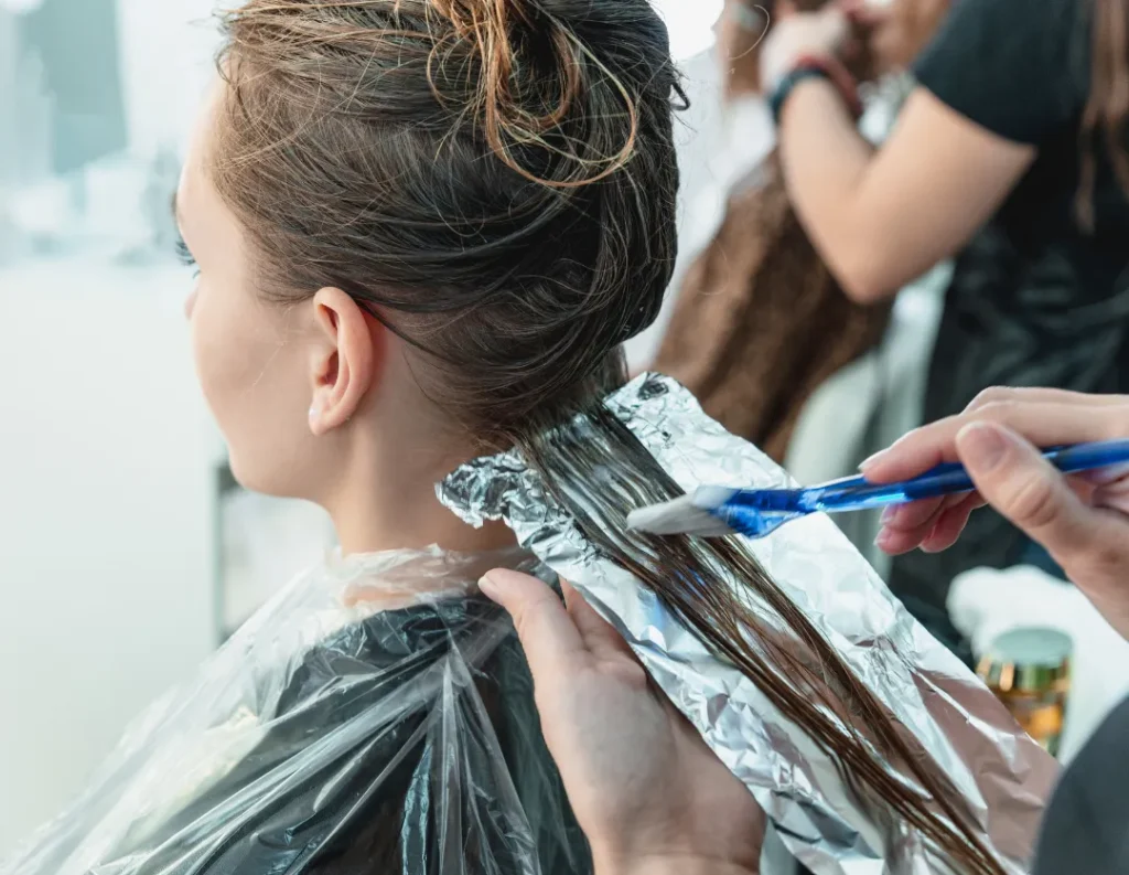 Professional hairstylist applying hair color to create a stylish and vibrant hair transformation Beauty Rajee Traends